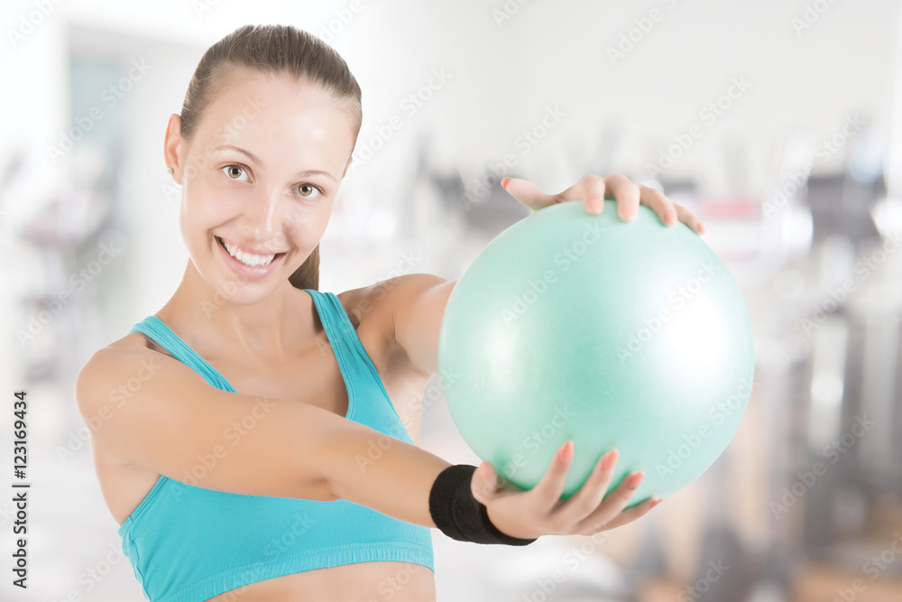 Fit Woman Standing Holding a Pilates Ball Fit Woman Standing Holding a Pilates Ball