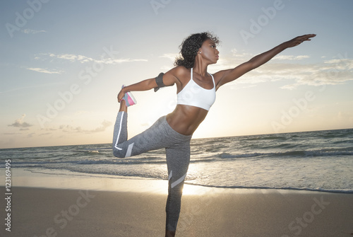 African american woman stretching on the beach