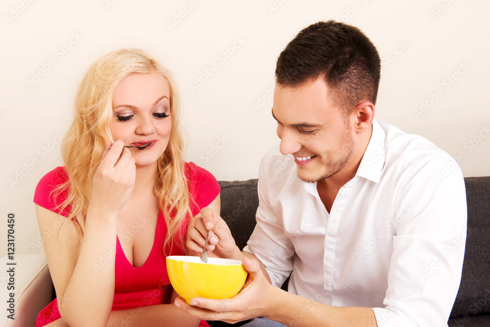 Lovely couple eating together from one bowl