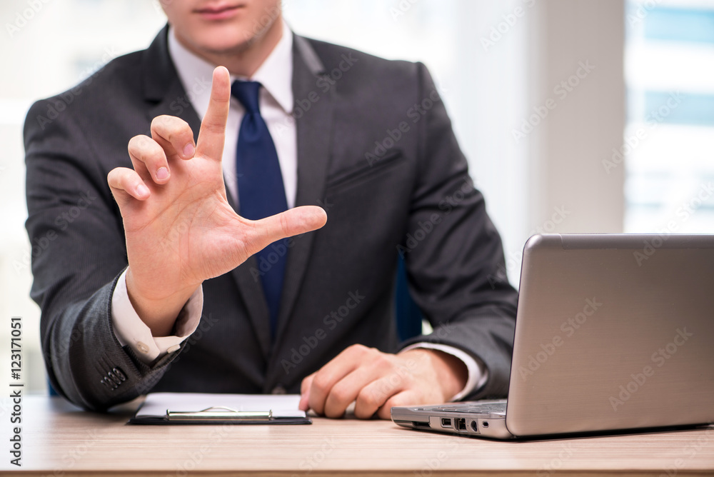 Young businessman pressing buttons in business concept Young businessman pressing buttons in business concept