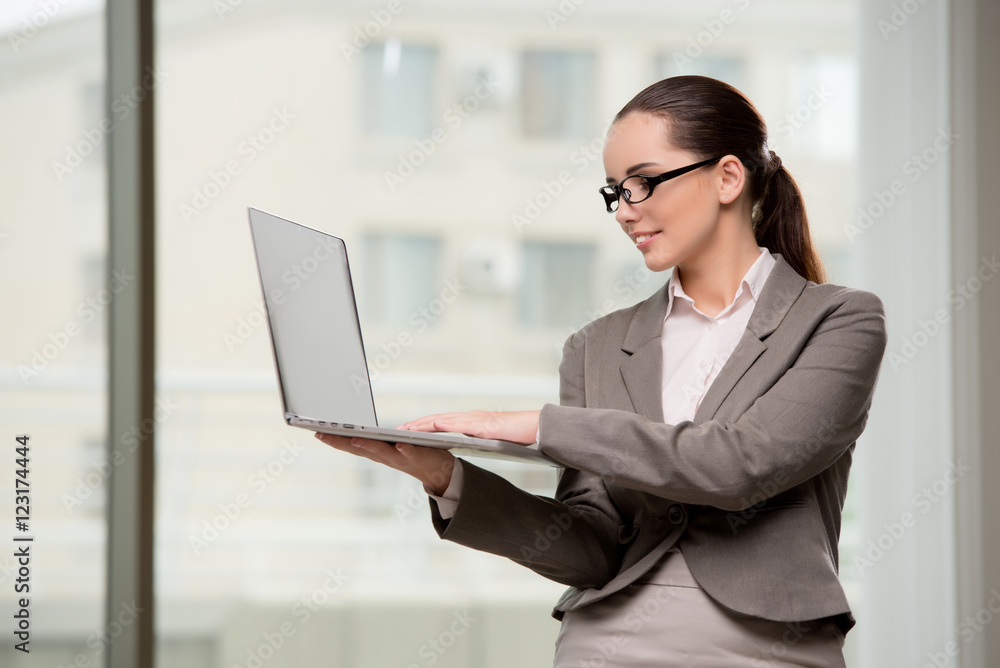 Young businesswoman working with laptop in business concept Young businesswoman working with laptop in business concept