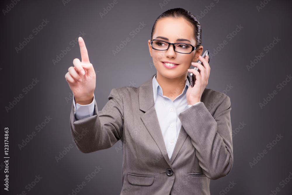 Businesswoman pressing virtual buttons in business concept Businesswoman pressing virtual buttons in business concept