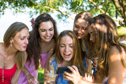 Young girls look in phone and lovely smile, a hen night