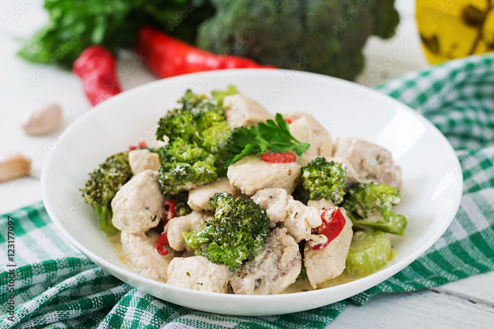 Delicate saute chicken with broccoli and chili peppers in a creamy garlic sauce Delicate saute chicken with broccoli and chili peppers in a creamy garlic sauce