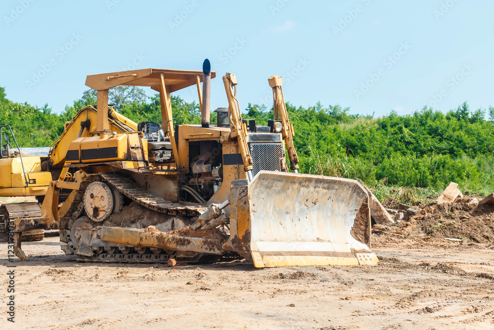 Closeup skid steer loader excavator at road construction work Closeup skid steer loader excavator at road construction work