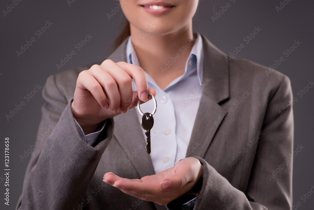 Woman holding keys in housing mortgage concept Woman holding keys in housing mortgage concept