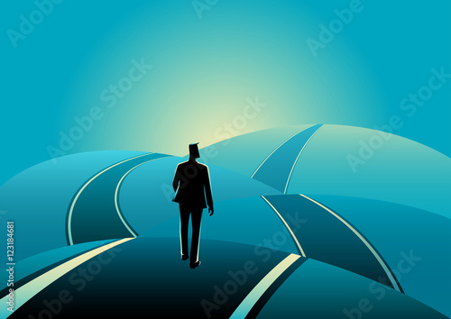 Businessman standing on the asphalt road over the hills