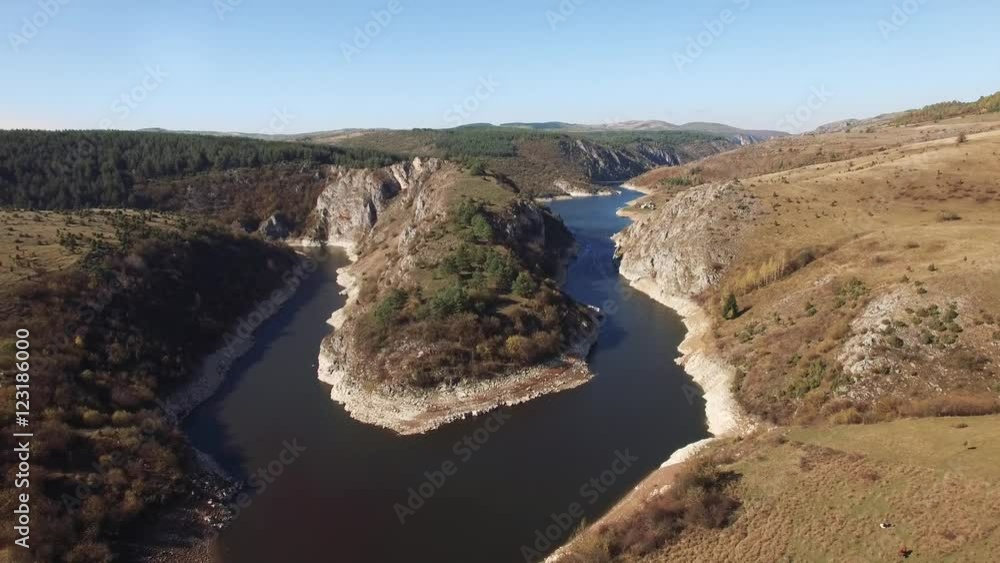 Aerial view on beautiful mountain river surrounded with autumn forest and mountains.
Aerial view on beautiful mountain river surrounded with autumn forest and mountains.