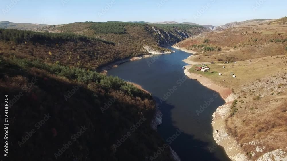 Aerial view on beautiful mountain river surrounded with autumn forest and mountains.
Aerial view on beautiful mountain river surrounded with autumn forest and mountains.