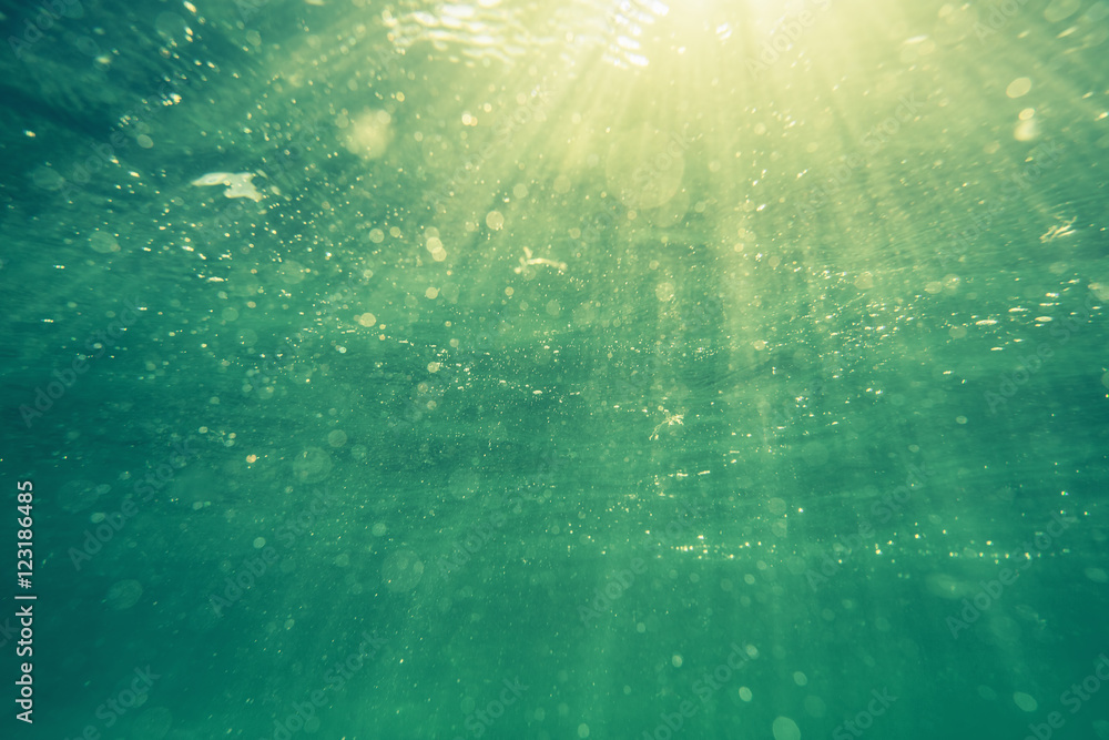 Fototapeta premium Underwater shot with sunrays and bubbles in deep tropical sea