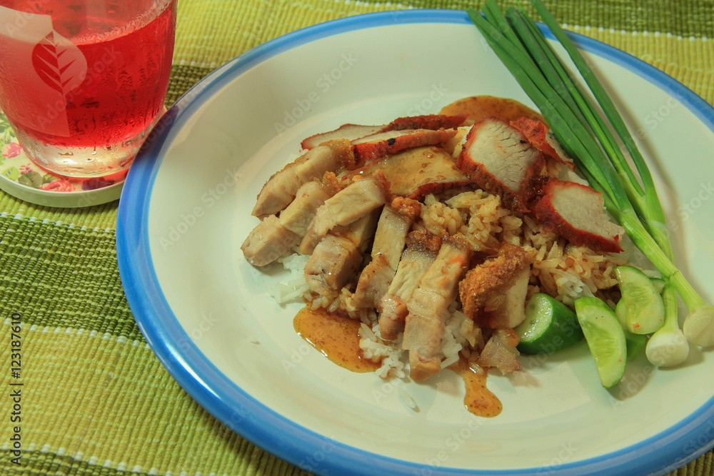 Thai food Barbecued red pork and crispy pork in sauce with rice and sweet drink