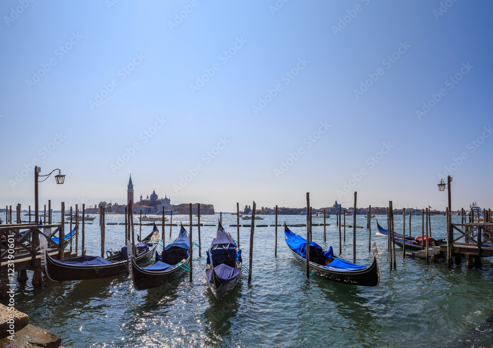 Gondolas on the background of the lagoon and the San Giorgio Maggiore island of Venice