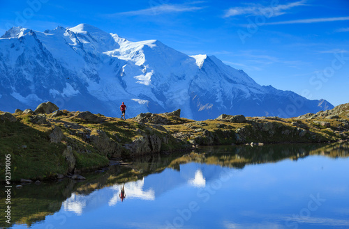 Man trail running at Lac De Chéserys, with the Mont Blanc in the background.