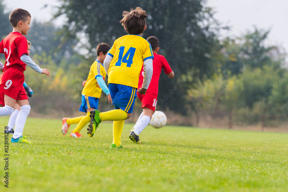 Obraz premium Boys kicking ball
