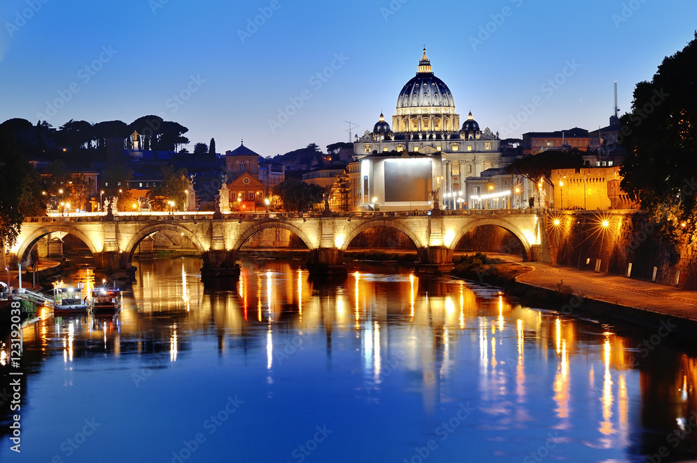 Rome, Italy - view of the Tiber river and St. Peter's Basilica at night