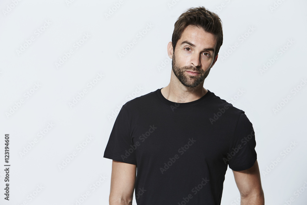 Obraz premium Black t-shirt guy in studio, portrait