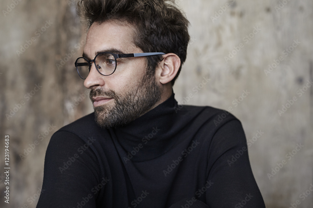 Man in black sweater and spectacles, looking away Man in black sweater and spectacles, looking away