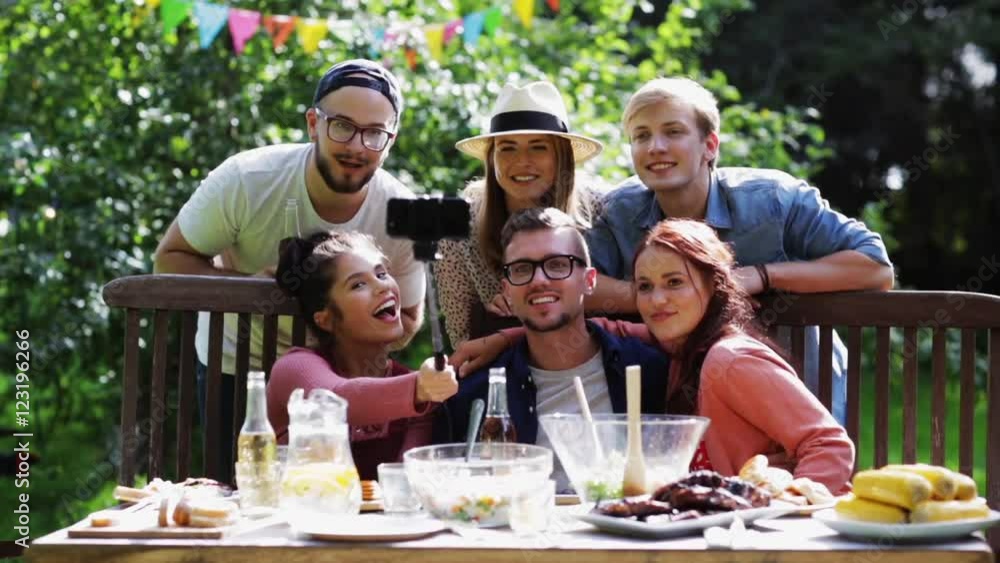friends taking selfie at party in summer garden friends taking selfie at party in summer garden