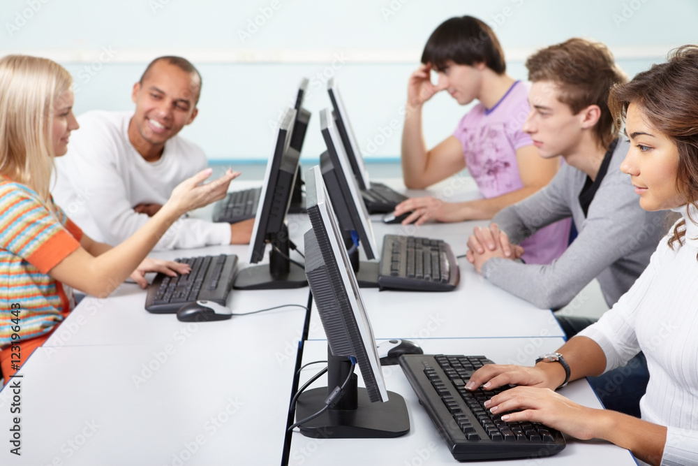 Five students are studying using computers Five students are studying using computers