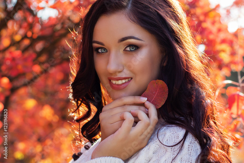 Beautiful smiling girl in colorful autumn park