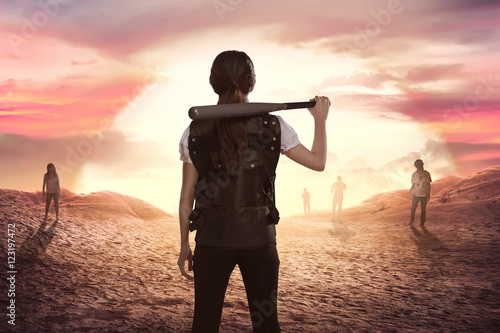 Photography Asian woman police with baseball bat in his shoulder looking at zombies