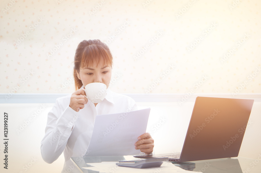 Young pretty business woman drink coffee with working in the cof Young pretty business woman drink coffee with working in the cof
