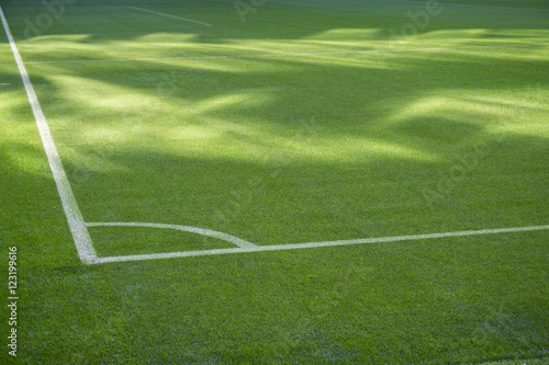 Football soccer field corner with white marks  green grass texture.