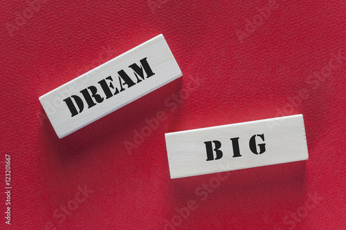 Dream big. Motivational message written on wooden tiles
