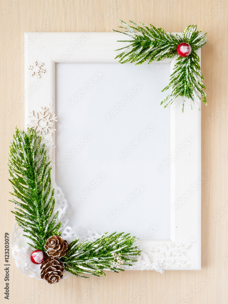 Fototapeta premium Photo frame decorated with fur-tree branches and cones