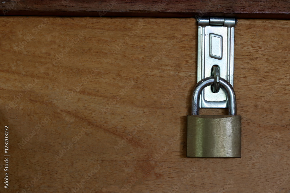 Fototapeta premium Master key is lock on wood background, blank on left background for message