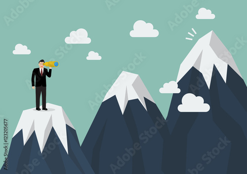 Businessman looking for mountain peak