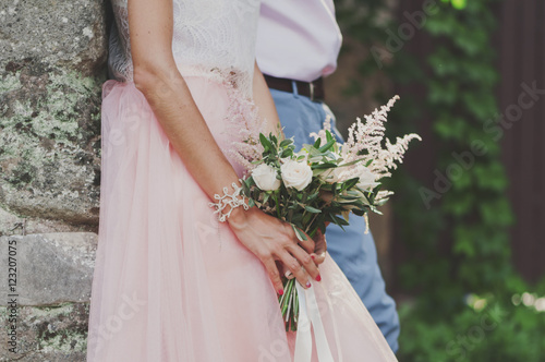 Beautiful wedding bouquet in hands of the bride