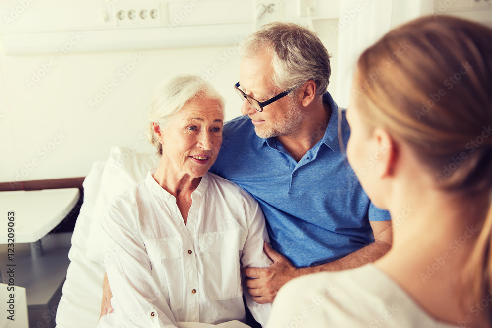 Fototapeta premium happy family visiting senior woman at hospital