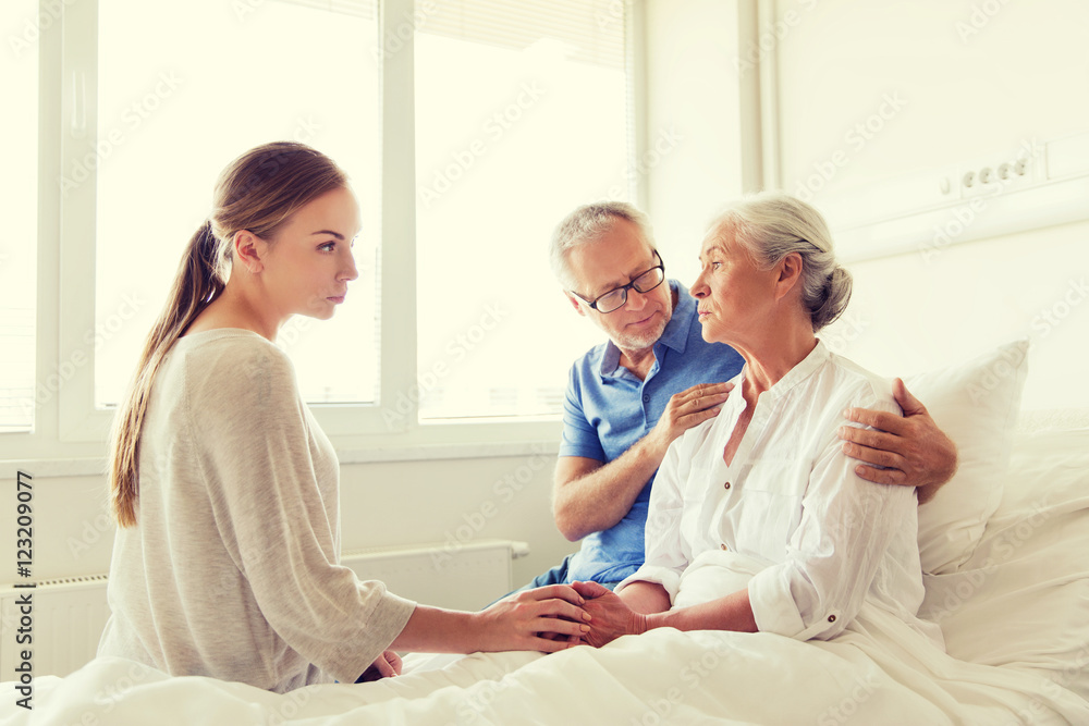 family visiting ill senior woman at hospital family visiting ill senior woman at hospital