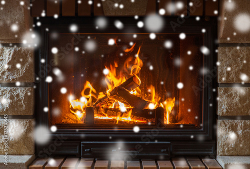 close up of burning fireplace with snow