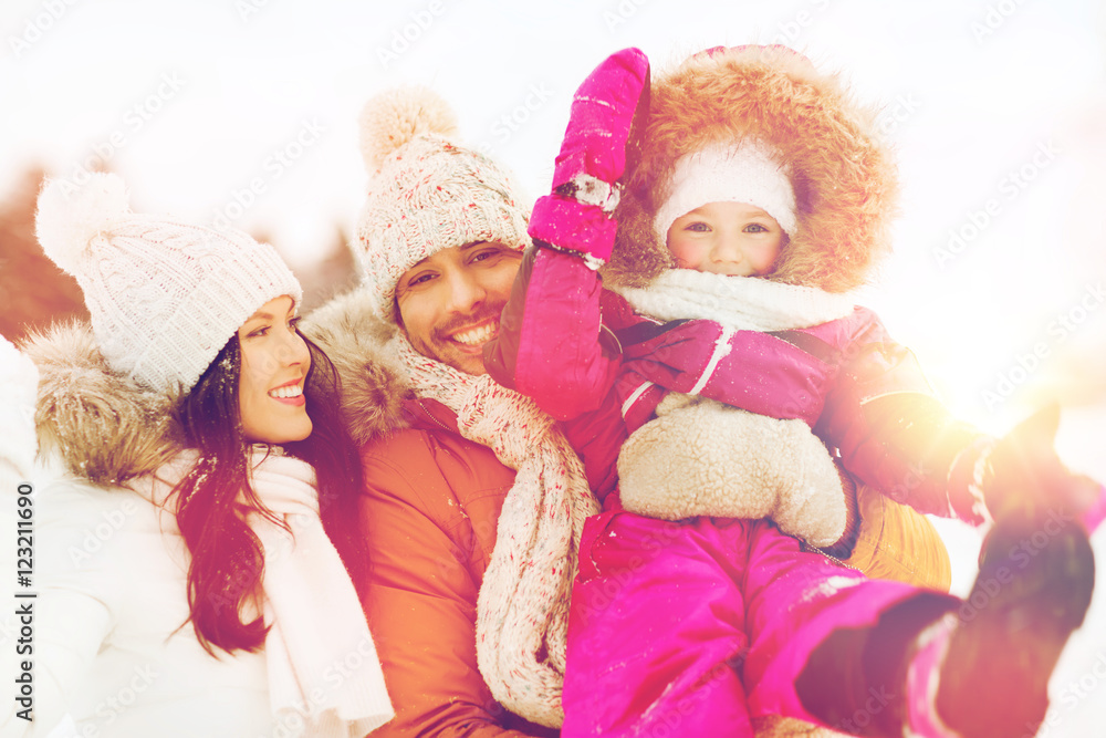 happy family with child in winter clothes outdoors happy family with child in winter clothes outdoors