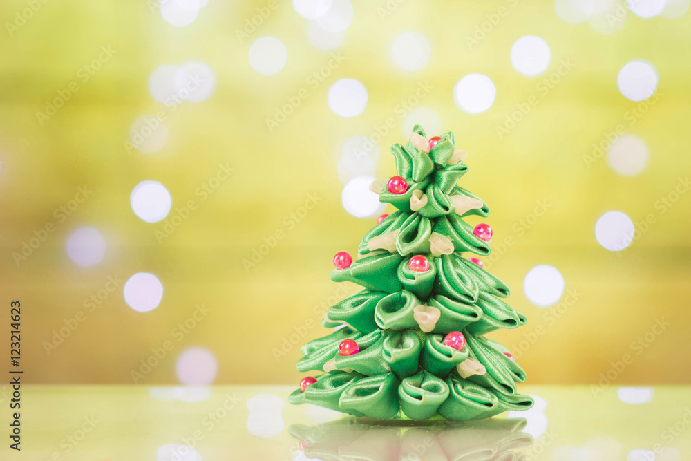 Blur light celebration on christmas tree with wall background