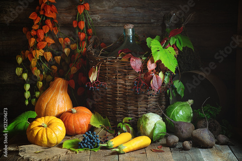 Autumn still life with vegetables  grapes and Chinese Lantern plants in rustic style