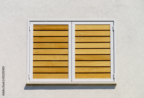 Window with shutters closeup view, sunny day on sea resort photo