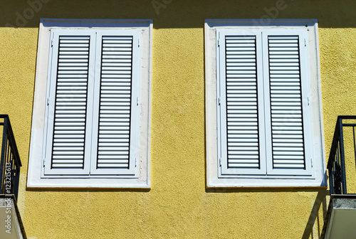 Window with shutters closeup view, sunny day on sea resort photo