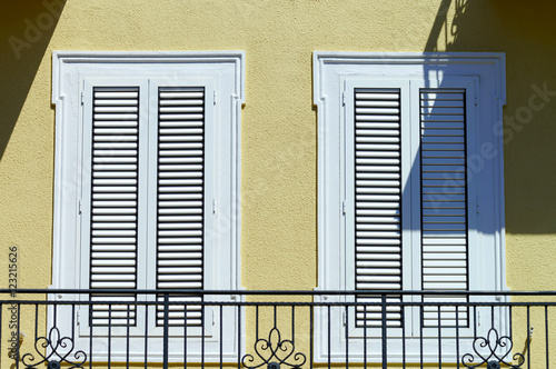 Window with shutters closeup view, sunny day on sea resort photo