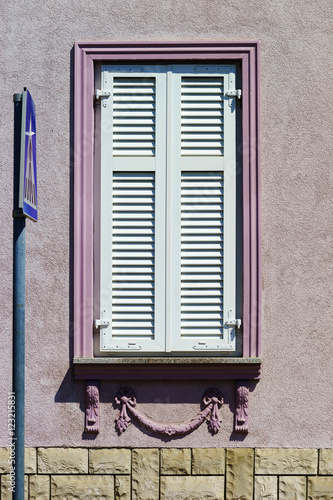 Window with shutters closeup view, sunny day on sea resort photo