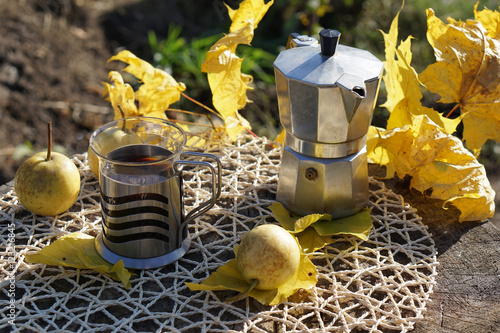 Coffee composition  with Autumn leaveson rustic background photo