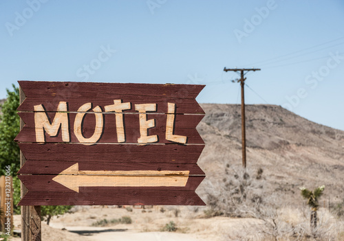 Vintage style motel sign direction in the mojave desert, California photo