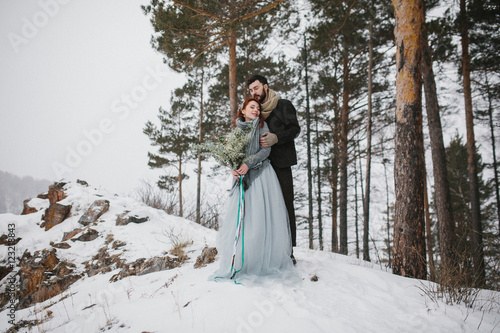 Young slim beautiful couple bride and groom embracing. Winter fo © horimono