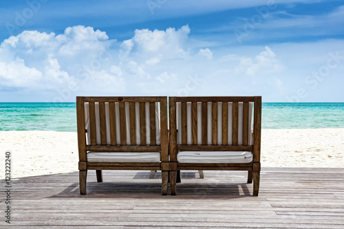 Wooden bench in front of blue ocean