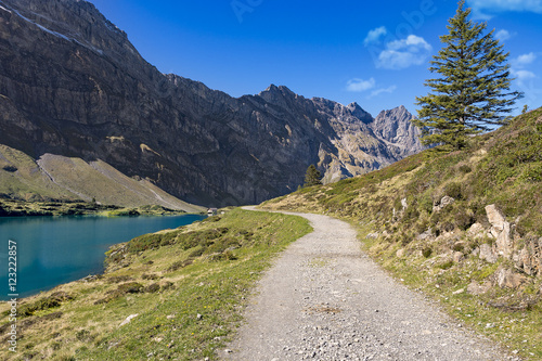 Hiking path along mountain lake landscape