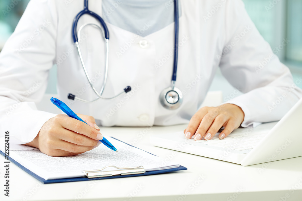 Hands of female doctor with a pen and documents Hands of female doctor with a pen and documents