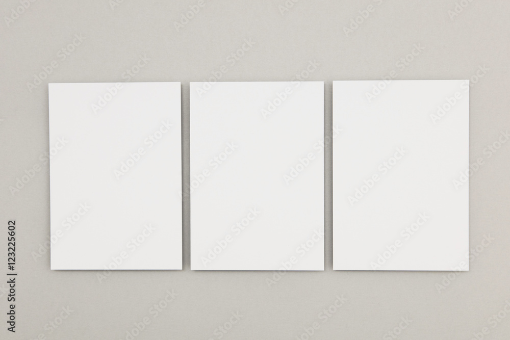 Blank white poster flyer on a grey background Blank white poster flyer on a grey background