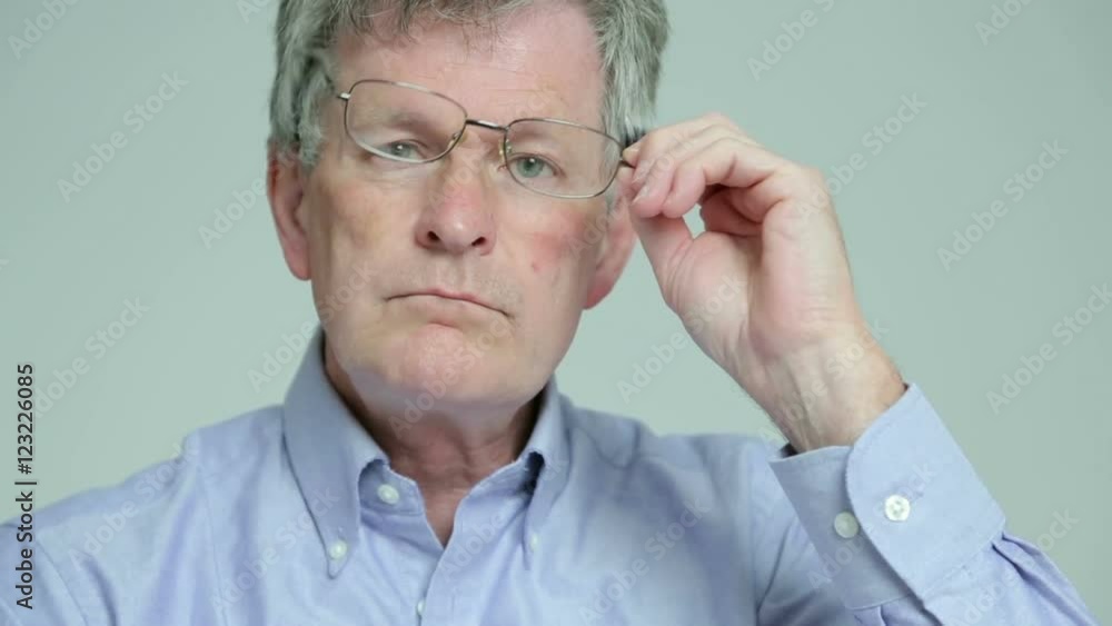 Depressed, sad man takes off glasses and sighs Depressed, sad man takes off glasses and sighs